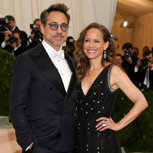 Robert Downey Jr. and Susan Levin at the Met Gala. Both dressed in formal attire, against a sea of celebrities and flashing cameras.