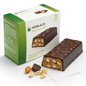 Herbalife protein bar box. Green and white packaging. Plain background. Chocolate covered bar with visible peanut pieces