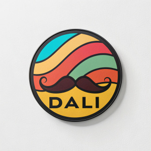 Salvador Dali's signature logo. Circular design, vibrant colors, features a mustache-like shape and the name 'DALI' in a stylized font. Modern art exhibition.
