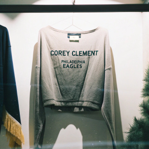 Corey Clement's gray Eagles t-shirt with his name and logo. Bright white background, showcasing the shirt's design. Feminine fashion product photo