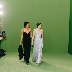 Jasmin Savoy Brown and Margaret Qualley attending the Critics Choice Awards. Elegant gowns, red carpet, logo-filled backdrop