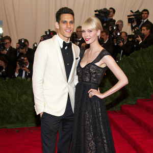 Gabe Saporta and Erin Fetherston at a glamorous event. They are posing on a red carpet, surrounded by paparazzi.