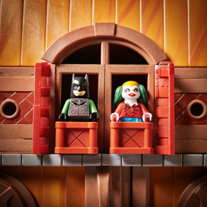 Package design for Fisher Price's Imaginext line, featuring Batman villains The Joker and Harley Quinn. Bright yellow backdrop with detailed illustrations. Toy figures showcased through a clear plastic window.