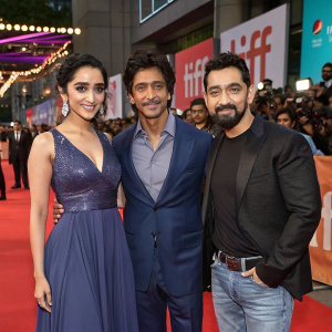 Shraddha Kapoor, Shah Rukh Khan, and Aamir Khan at a bustling film festival. Each actor has their unique pose and attire.
