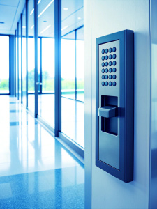 Finger print scan access control system machine on wall near entrance door office