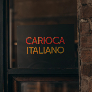Carioca Italiano logo features bold, modern design. Bright colors explode from text. Against vivid yellow backdrop, conveying energy and excitement. Simple yet dynamic, highlights brand's Italian roots.