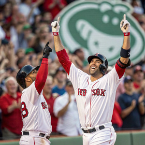 J.D. Martinez and Ezequiel Carrera celebrating a home run. Fenway Park, cheering crowd in the background.