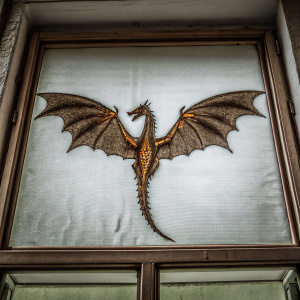 A vibrant pixel art piece featuring a majestic dragon. The dragon's wings are spread wide, showcasing detailed brown scales with a subtle golden hue at its core. The background remains a simple white, allowing the dragon to take center stage in this animated scene.
