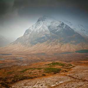 Vast landscape of the rugged, snow-capped Buachaille Etive Mòr in Scotland's dramatic wilderness.