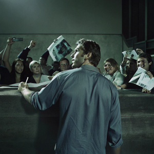 Jarret Stoll, in a casual blue shirt, at a sports memorabilia signing event. Crowd cheering