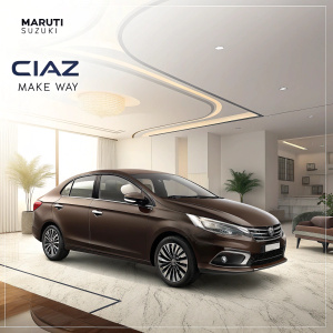 Promotional ad featuring Maruti Suzuki Ciaz. Sleek brown sedan showcased in a modern showroom with stylish interiors. Highlights luxury features and special end-of-year offer. Text includes pricing details and 'Ciaz Make Way' slogan.