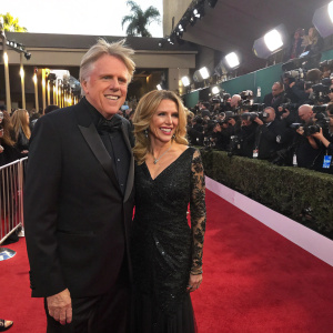Gary Busey and Maria Elena Holly at a glitzy awards ceremony. Red carpet surrounded by paparazzi and fans