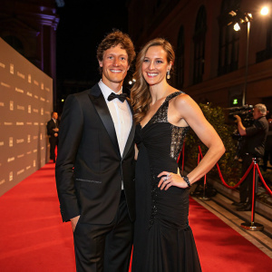 Sebastian Kienle and Christine Schleifer, in elegant evening wear, attending the Academy Awards ceremony.