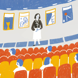 Emilia Clarke, dressed in a black blazer paired with a white pencil skirt, at a Q&A session. Crowded auditorium with banners and posters