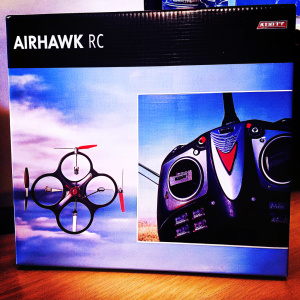 Eye-catching packaging design for the Airhawk RC flying gadget. Modern black and blue color scheme. Detailed graphics highlighting drone features and brand identity.