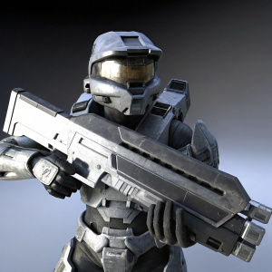 Spartan warrior from Halo, in combat-ready pose. Large, futuristic weapon held close. Detailed armor and weapon structures. Plain black background.