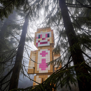 A pixelated Minecraft rendition of FNAF Chica, featuring a wide grin and small black eyes. The character is made entirely of blocks in shades of brown and pink against a dark backdrop.