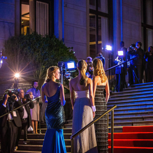 Sailor Brinkley Cook, Kaia Gerber, and Cami Morrone at the Met Gala. Red carpet, flashing cameras.