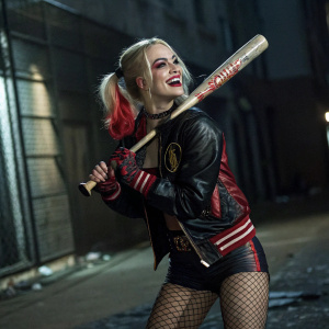 Harley Quinn from the Suicide Squad comic book series. Bold makeup, confident smirk, playful yet fierce demeanor. Wearing a black and red jumpsuit, fishnet stockings, and a baseball bat. Dark and gritty urban background.
