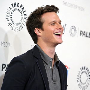 Jonathan Groff, smiling and energetic, at the Paley Center event. White backdrop