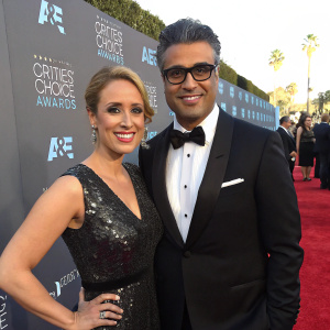 Heidi Balvanera and Jaime Camil attending the 21st Annual Critics' Choice Awards gala. Heidi wearing a shimmering black dress, Jaime in a classic tuxedo. Red carpet backdrop with A&E logo.