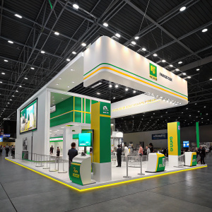 Petrobras booth at a bustling auto expo. Sleek design, vibrant white, green, and yellow colors. High-tech displays, barriers, and bright lighting set the scene.