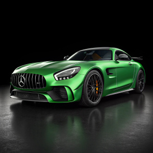 3D rendering of a sleek green Mercedes-AMG GT R sports car. Black background. Car's prominent front grille, sharp lines, and low profile highlighted by dynamic lighting.