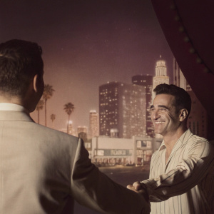 Jimmy Kimmel and Colin Farrell shaking hands on the vibrant set of Jimmy Kimmel Live. The backdrop features an animated skyline of Los Angeles.