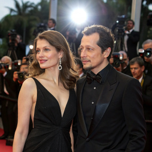 Laetitia Casta and Stefano Accorsi at a glitzy Hollywood premiere. Both dressed in formal attire, walking the carpet under flashing lights.