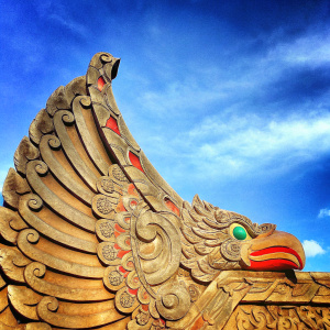 High-resolution image of intricate Garuda sculpture. Detailed carving and vibrant colors