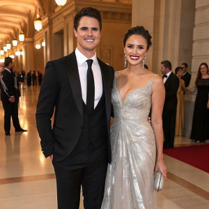 Robbie Amell and Italia Ricci, dressed in formal attire, attending a gala event.