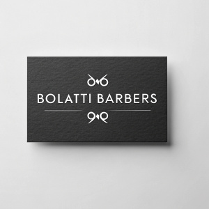 Business cards for Bolatti Barbers. Minimalist design, black background, white text. Modern and sleek.