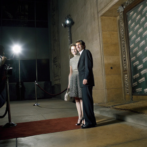 Leonard Nimoy and Susan Bay at a Hollywood premiere. Wearing formal attire, they stand on a red carpeted area with a backdrop featuring Star Trek and sponsor logos. Both have a friendly demeanor.