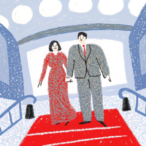 Irene Villa and Juan Pablo Lauro at a glamorous gala. Irene in a red lace dress, Juan Pablo in a gray suit. Red carpet with Cuatro TV logo