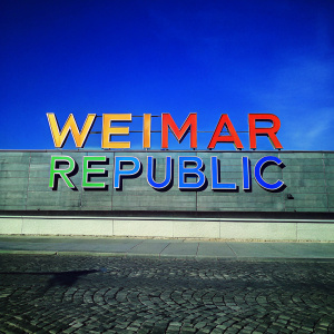 The Weimar Republic logo in a modern redesign. Bright neon colors on a sleek black backdrop.