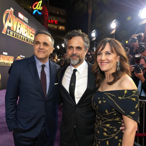 Joe Russo, Mark Ruffalo, and Victoria Alonso at the world premiere of Avengers Infinity War. Strobe lights and paparazzi in background
