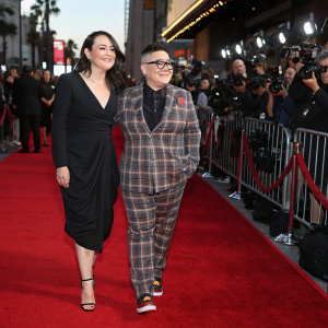 Dalia Gladstone and Lea DeLaria at the movie premiere. Dalia in plaid suit, Lea in black dress. Red carpet event with flashing cameras