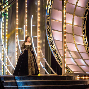 Natalie Portman in elegant evening gown, at awards ceremony. Richly detailed black velvet gown, adorned with intricate beadwork. High resolution close-up. Soft, dramatic lighting.