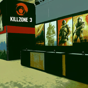 Killzone 3 exhibit at the gaming convention. Black and red booth design with large logos and detailed sketches.