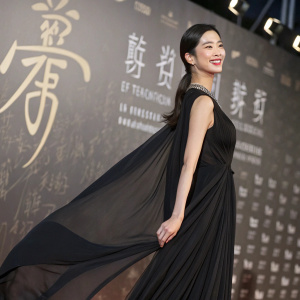 Clara Lee, South Korean actress, confidently posing at Cannes Film Festival. She wears a flowing black dress. Textured background with Chinese characters, spotlight on Clara