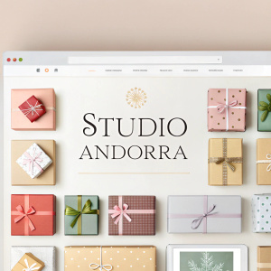 Página web para Studio Andorra. Grid de caixas de presentes em diferentes tamanhos e cores. Paleta de cores suave e convidativa, misturando tons neutros e pastel. Texto em português.