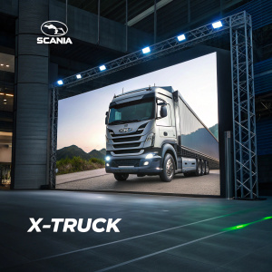 Advertisement for Scania's X-Truck series. Modern digital display showcasing truck's sleek design and utility features. Dark background. High-resolution image with clean, contemporary font for branding and text.