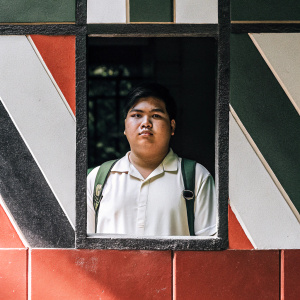 Aldrin B. Bacordio, student of City of Malabon Polytechnic Institute. Official student ID photo. Background features a mix of geometric shapes and bold colors.