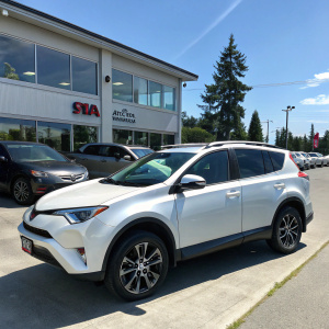 For sale: Toyota RAV4 in pristine condition at Evia Auto Sales. Shown parked amidst other vehicles and the dealership building.