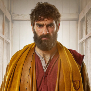 Mile Jedinak, serious look, full beard, in an Aston Villa FC jersey, plain white backdrop. Event promotional photo