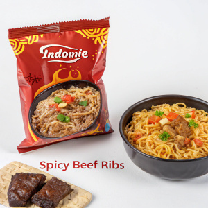 A package of Indomie Spicy Beef Ribs flavor instant noodles. Shiny packaging with brand logo and flavor details. Picture of noodle dish included. Plain white background