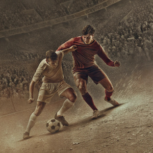 Cristiano Ronaldo and Gareth Barry competing for the ball in a packed stadium. Intense soccer match captured in a dynamic photo.