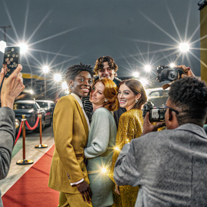 RJ Cyler, Shannon Purser, Noah Centineo, and Kristine Froseth attending a Hollywood outdoor event. Bright lights and paparazzi