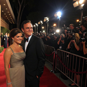 Tiffani-Amber Thiessen and Tim Dekay at a Hollywood gala. Red carpet event with paparazzi snapping photos, flashing lights everywhere.