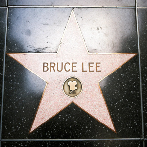 Bruce Lee's star on Hollywood Walk of Fame. Black background, with glowing red and gold star